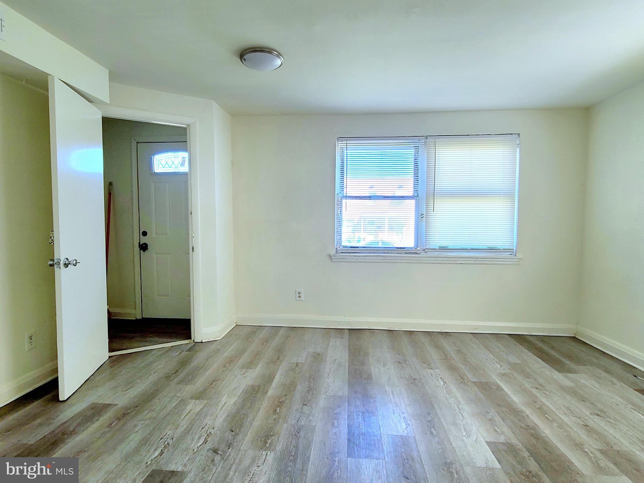 8520 Chestnut Oak Road Parkville, MD 21234 - Photo 20 of 28 an empty room with wooden floor and windows