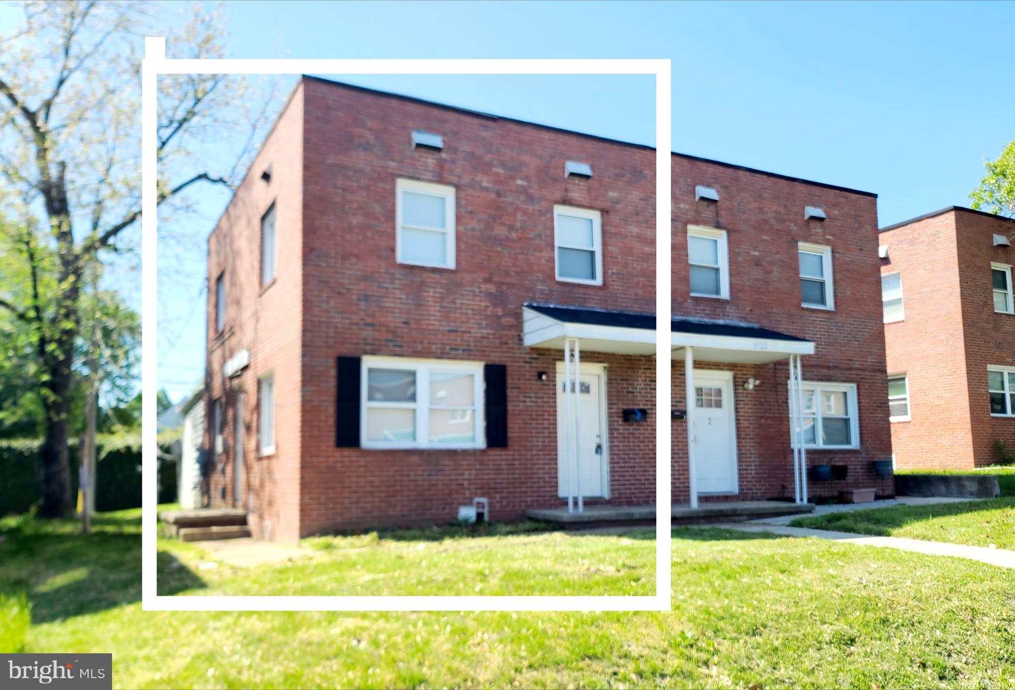 8520 Chestnut Oak Road Parkville, MD 21234 - Photo 2 of 28 a view of a brick building with a yard