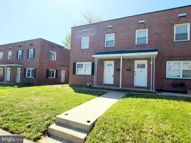 a view of a brick building next to a yard