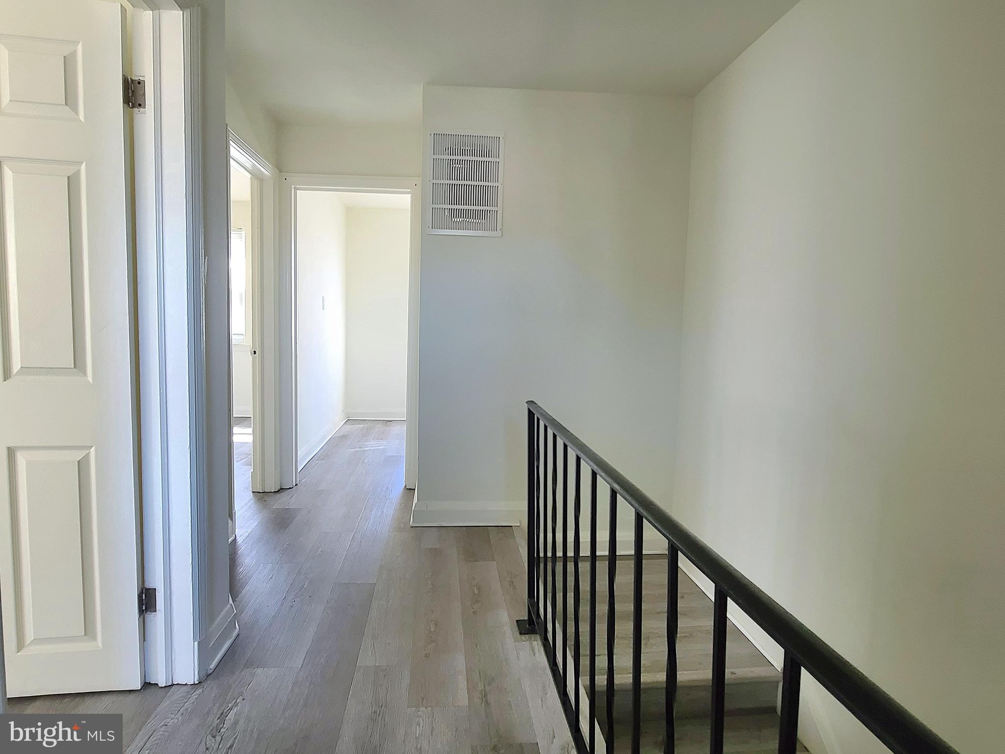 8520 Chestnut Oak Road Parkville, MD 21234 - Photo 8 of 28 a view of a hallway with wooden floor