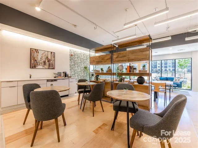 a dining room with furniture and a large window