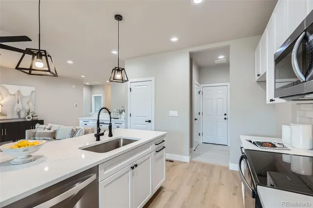a kitchen with stainless steel appliances a sink stove and refrigerator