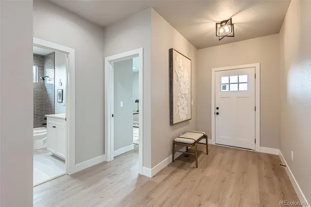 a view of a room with wooden floor and bathroom