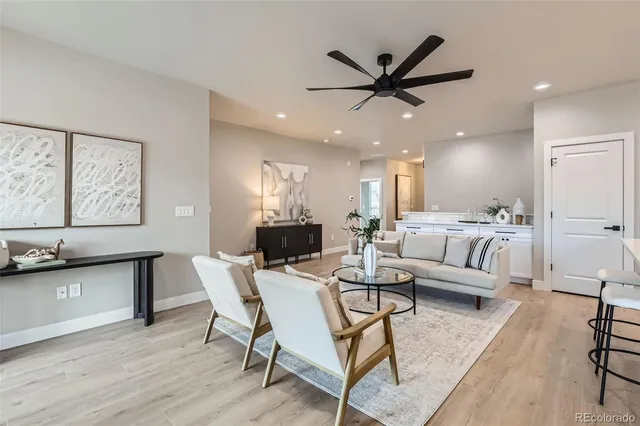 a view of a dining room with furniture and a ceiling fan