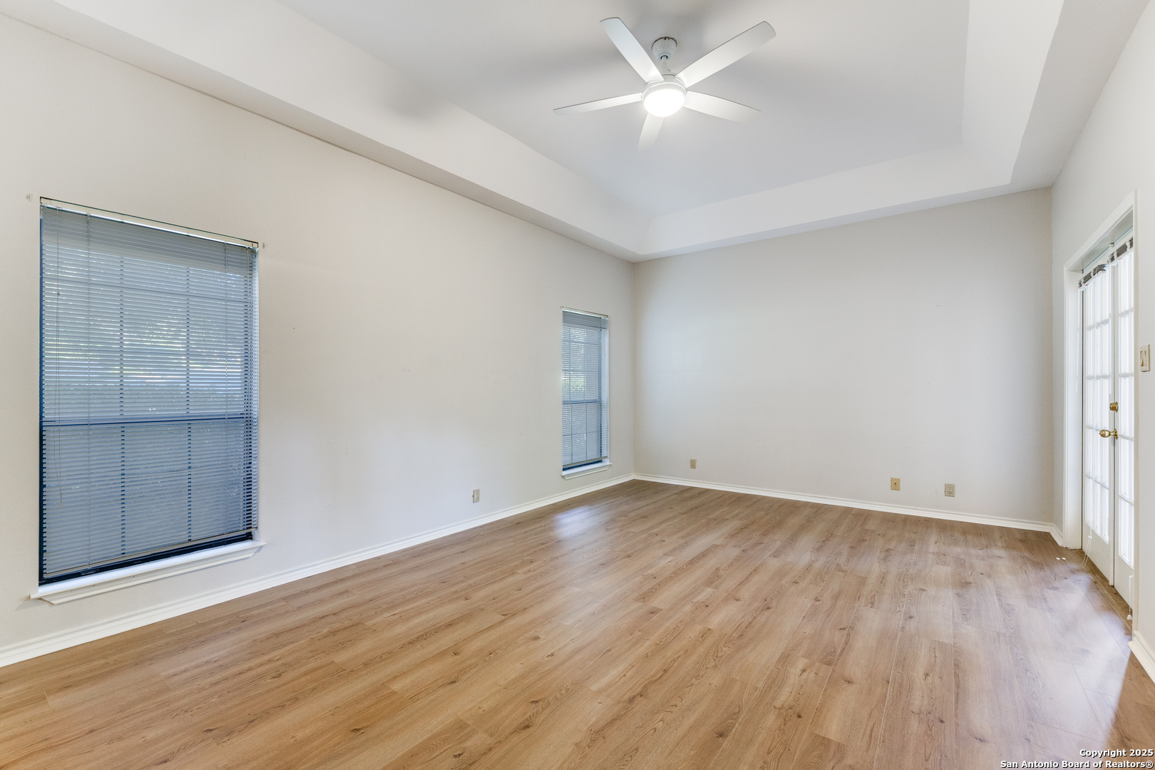 15558 Clover Ridge San Antonio, TX 78248 - Photo 16 of 29 an empty room with wooden floor and windows