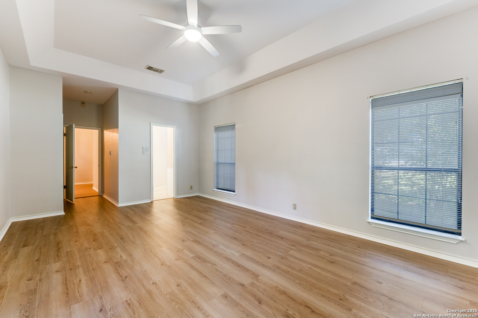 15558 Clover Ridge San Antonio, TX 78248 - Photo 17 of 29 an empty room with wooden floor and windows