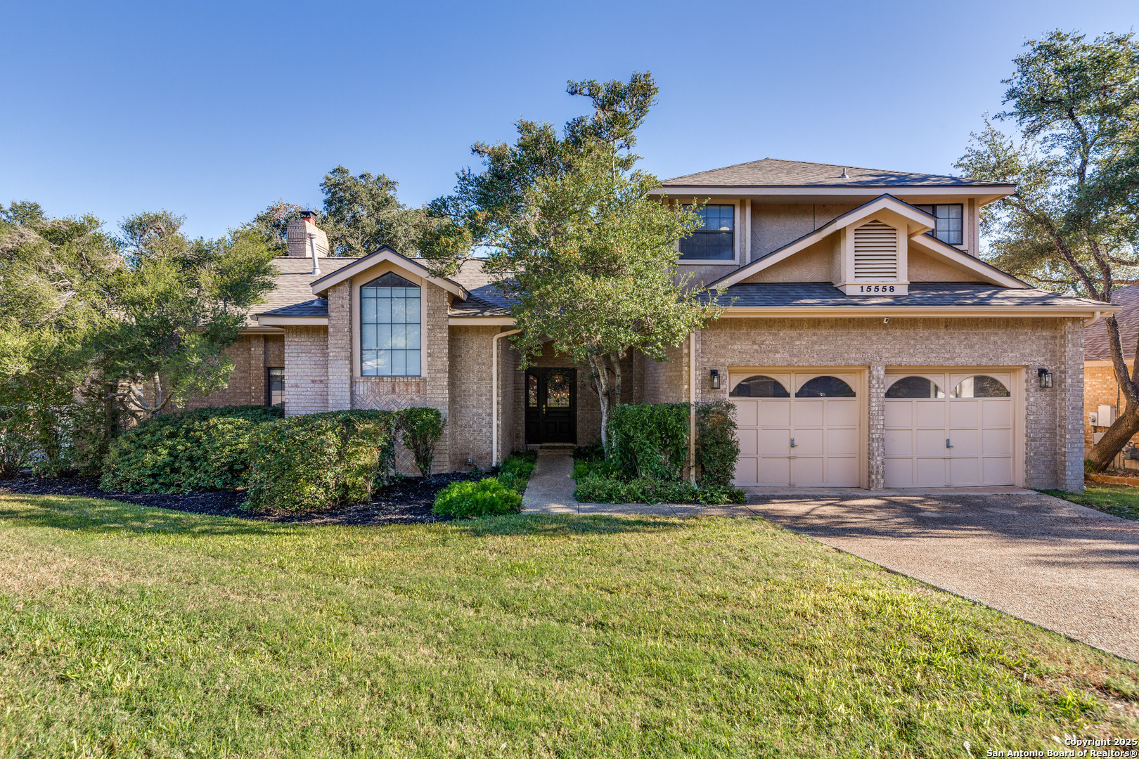 15558 Clover Ridge San Antonio, TX 78248 - Photo 2 of 29 a front view of a house with a yard and garage