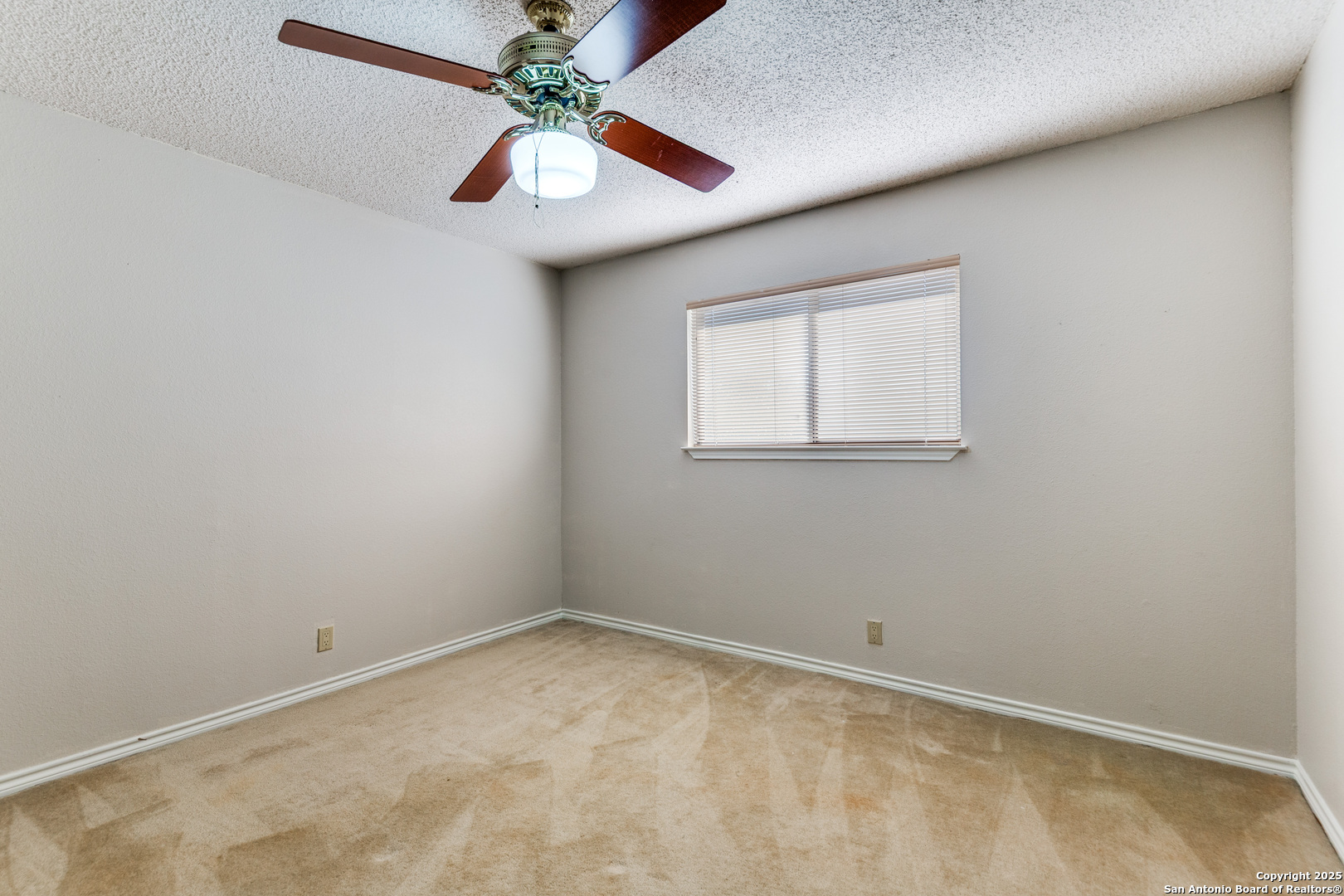 15558 Clover Ridge San Antonio, TX 78248 - Photo 23 of 29 an empty room with a window and a fan