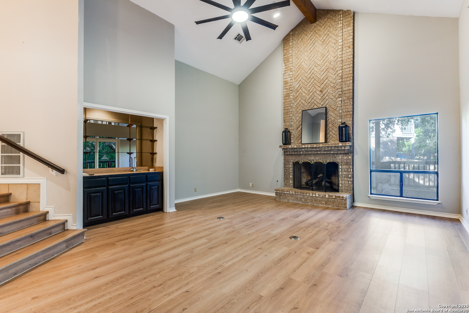 15558 Clover Ridge San Antonio, TX 78248 - Photo 5 of 29 a view of an empty room with wooden floor fireplace and a window