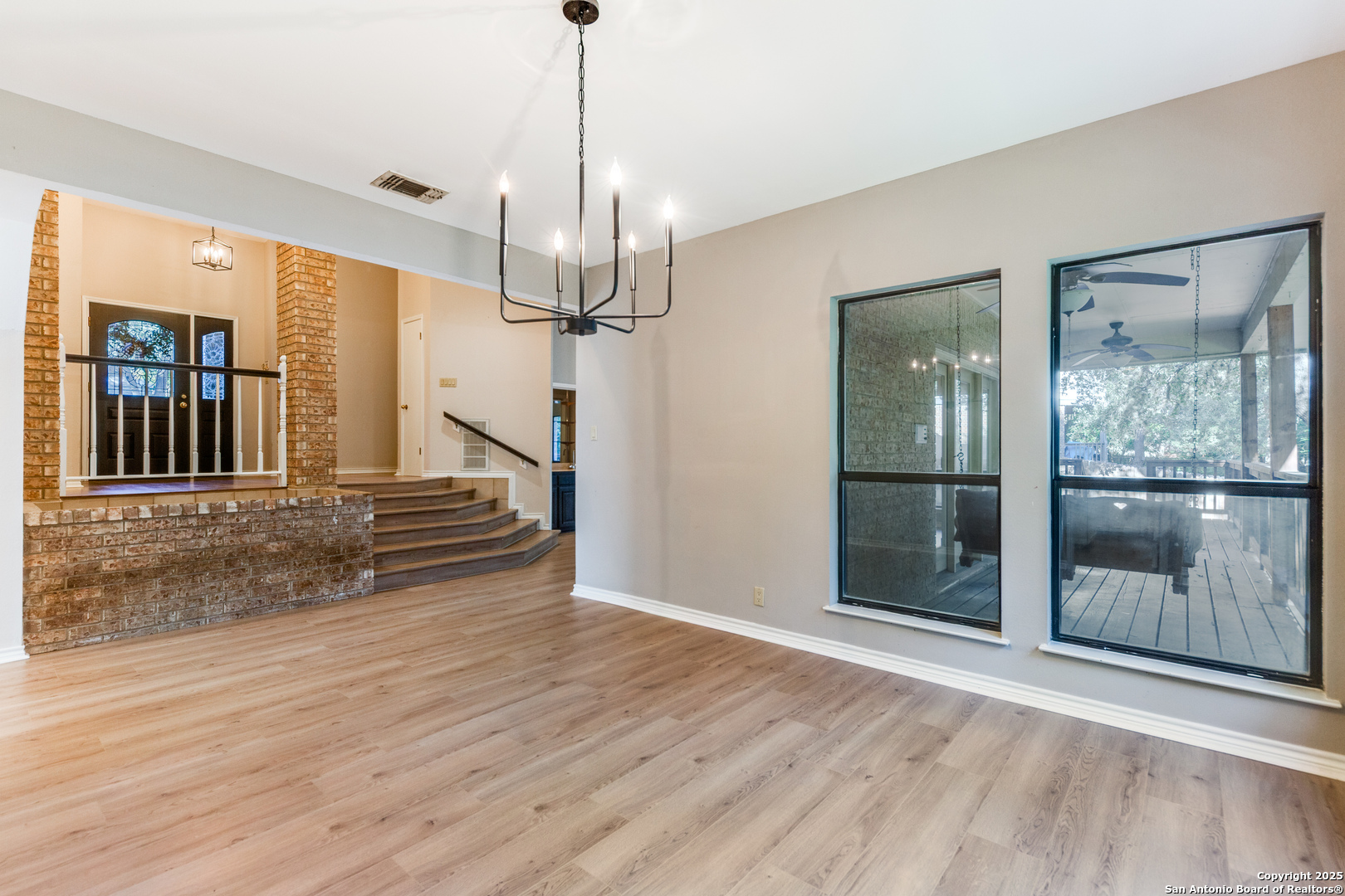 15558 Clover Ridge San Antonio, TX 78248 - Photo 7 of 29 a view of a room with wooden floor staircase and windows