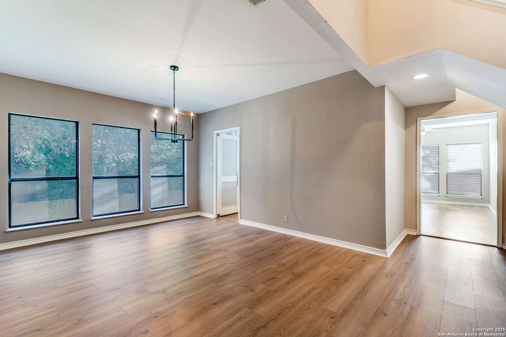 15558 Clover Ridge San Antonio, TX 78248 - Photo 10 of 29 a view of an empty room with wooden floor and a window