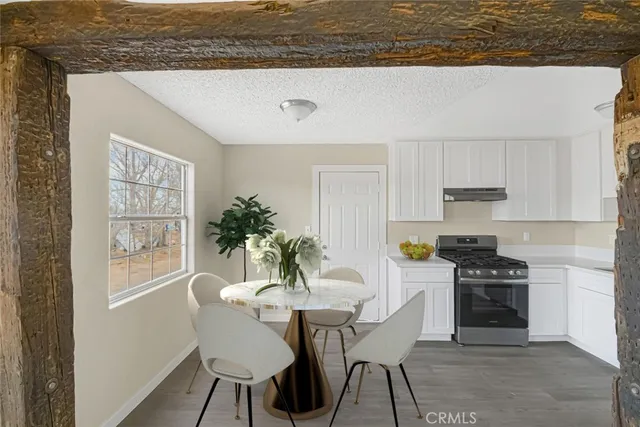 a kitchen with stainless steel appliances granite countertop a stove a sink and a white cabinets
