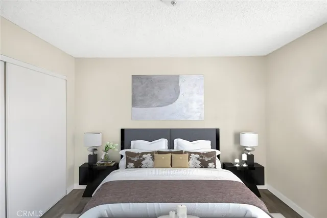 a bed room with a bed and a lamp with wall painting