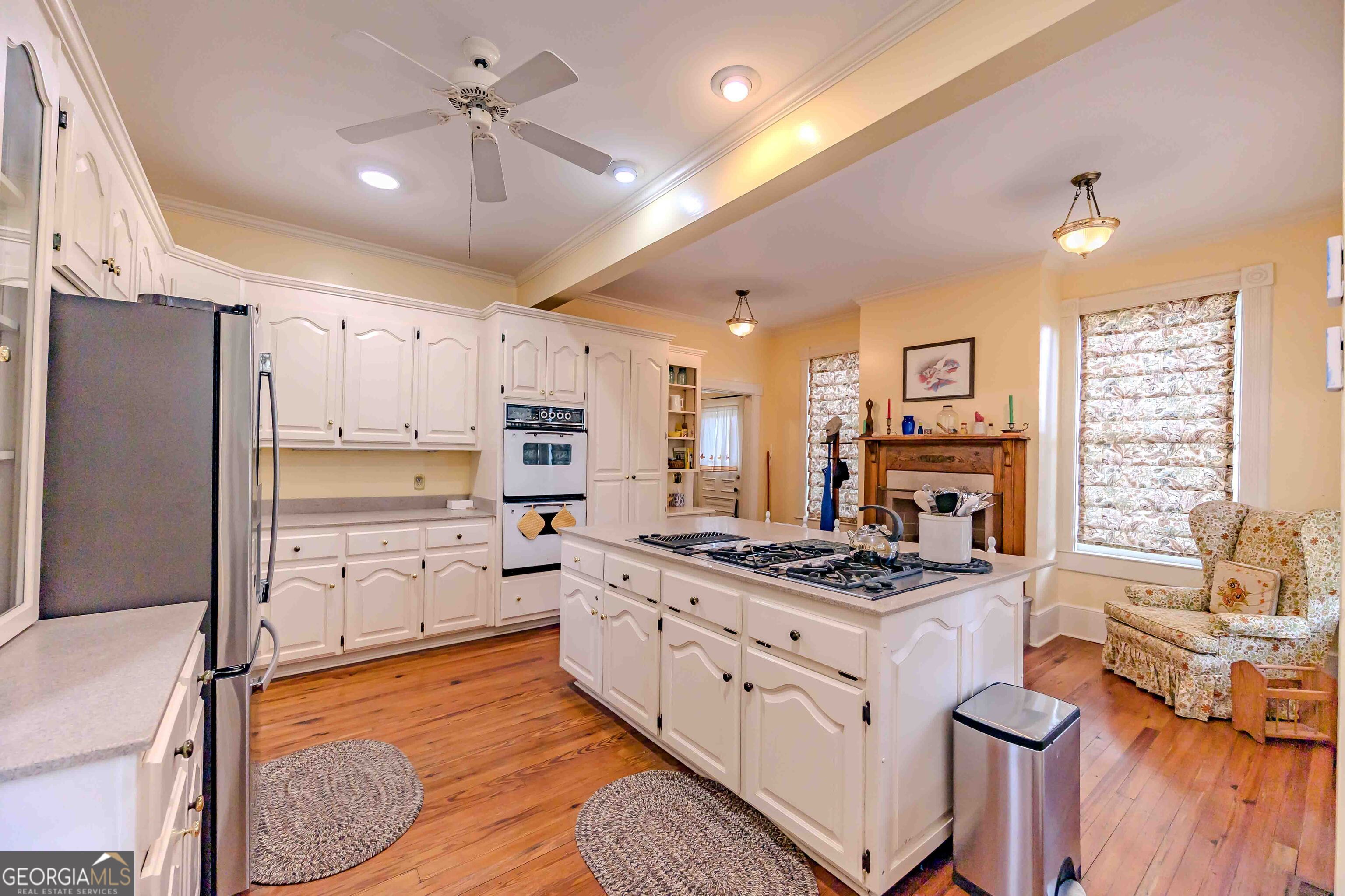 39 West Graham Street McRae-Helena, GA 31055 - Photo 32 of 107 a kitchen with stainless steel appliances a stove a sink dishwasher a refrigerator white cabinets with wooden floor