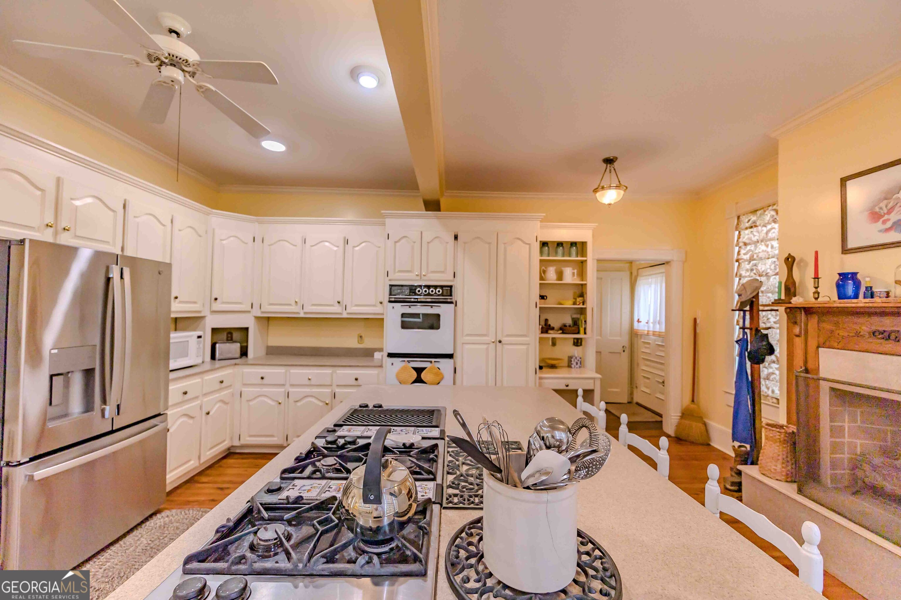 39 West Graham Street McRae-Helena, GA 31055 - Photo 33 of 107 a kitchen with stainless steel appliances kitchen island granite countertop a refrigerator and a stove top oven