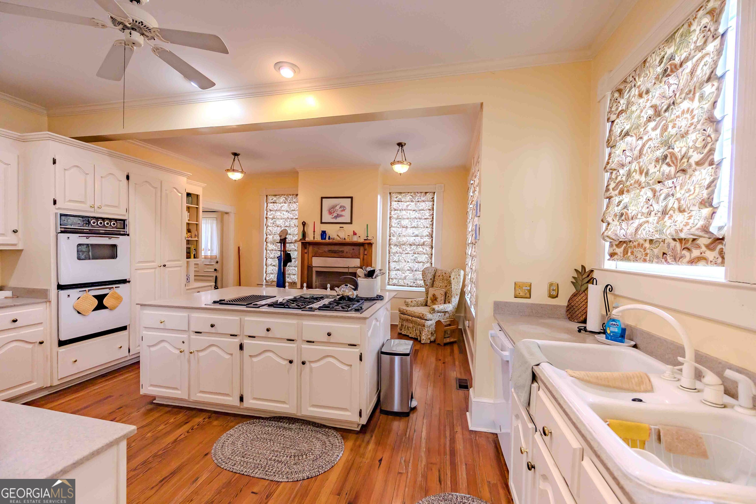39 West Graham Street McRae-Helena, GA 31055 - Photo 35 of 107 a large white kitchen with a large window a sink and cabinets