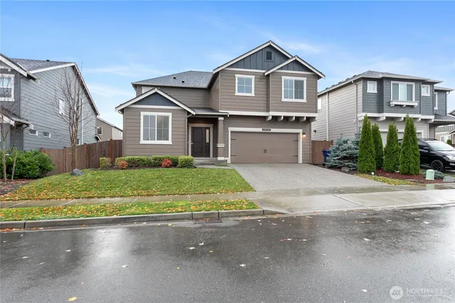 a front view of house with yard and green space