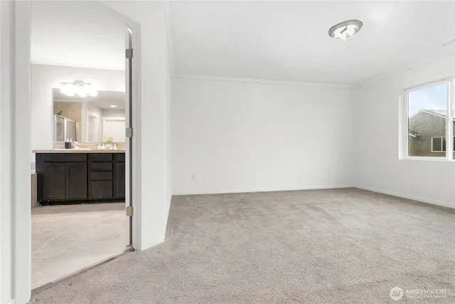 an empty room with a cabinet and mirrors