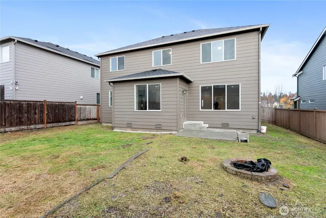 a backyard of a house with yard and outdoor seating