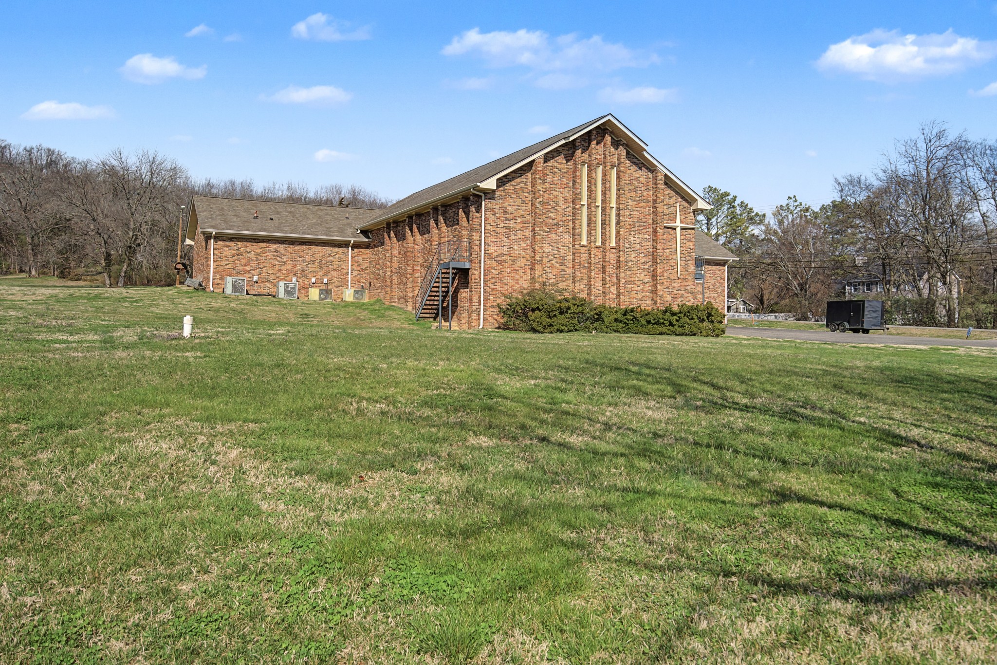 1301 Franklin Road Brentwood, TN 37027 - Photo 2 of 15 a view of a big house with a big yard and large trees