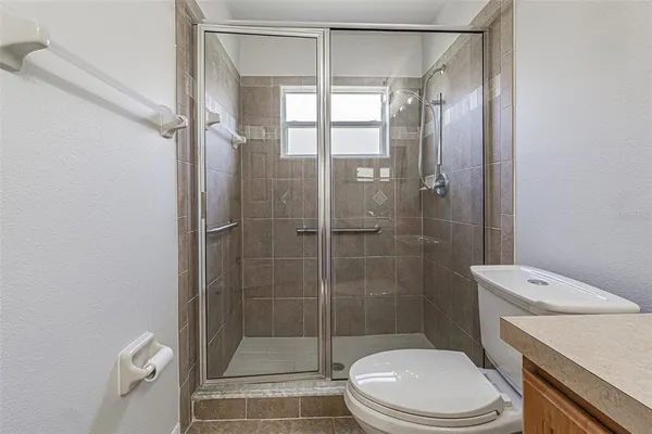 a bathroom with a toilet and a shower