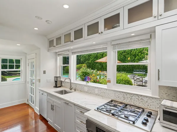 a kitchen with a stove a sink and a window