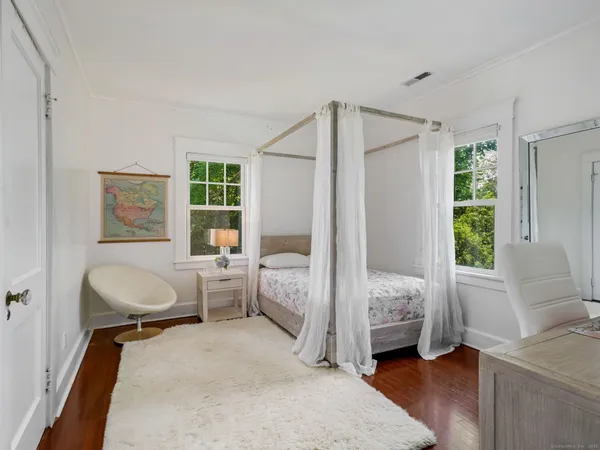 a bedroom with furniture and a window