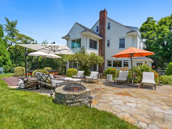 a view of a patio with furniture and table under an umbrella