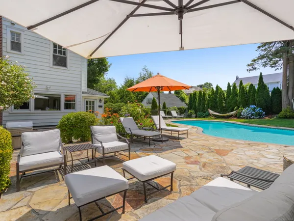 a view of a backyard with furniture and a garden