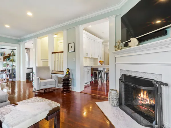 a living room with furniture a fireplace and a floor to ceiling window