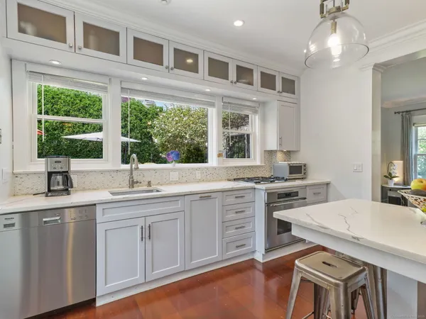 a kitchen with stainless steel appliances granite countertop a stove and cabinets