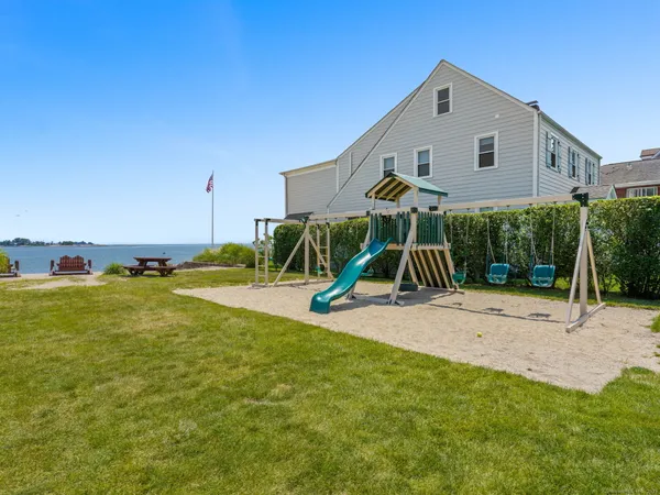 a view of a house with a yard and sitting area