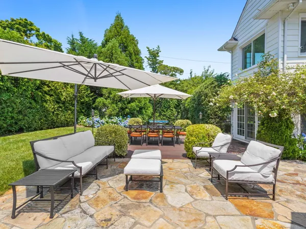 a patio with patio a table and chairs under an umbrella