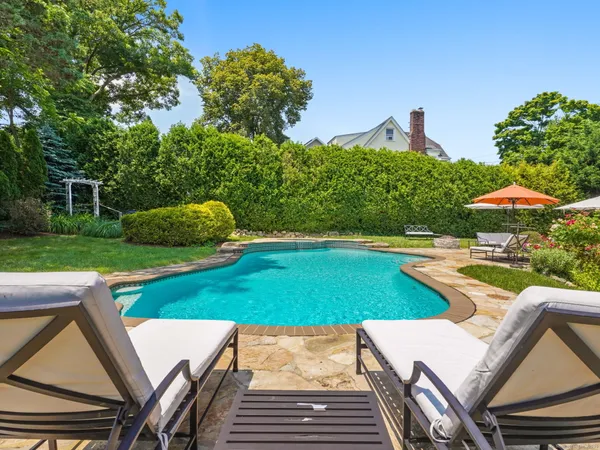 swimming pool view with a seating space