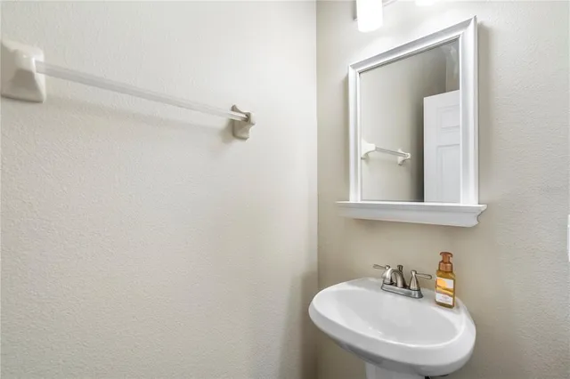 a bathroom with a sink a mirror and a toilet