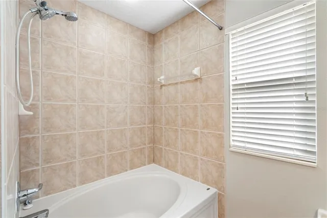 a bath tub sitting next to a white sink