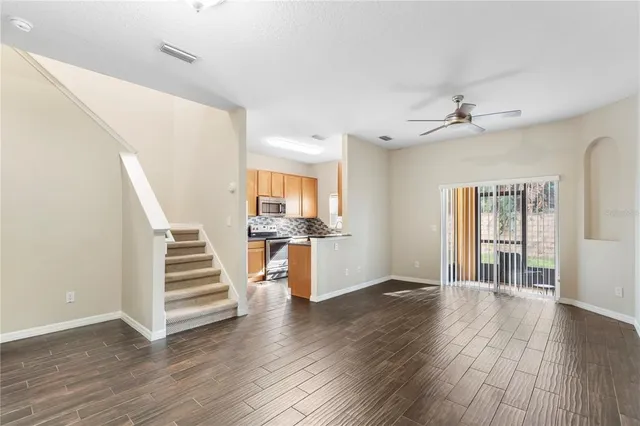 wooden floor in an empty room with a window and wooden floor