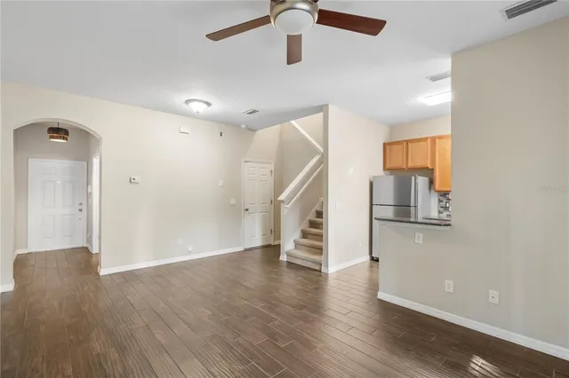 an empty room with wooden floor and entryway