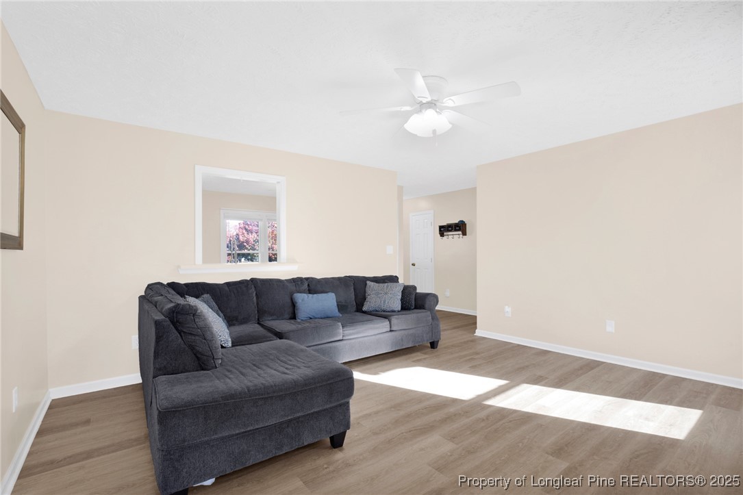 101 2 Hours Court Raeford, NC 28376 - Photo 6 of 30 a living room with furniture and a wooden floor