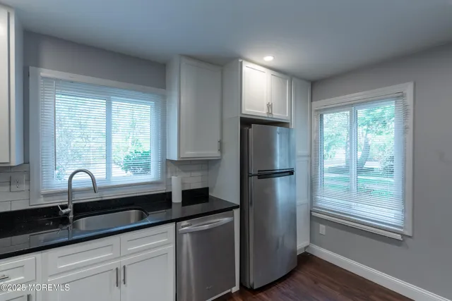 a kitchen with a refrigerator and a sink