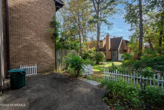 a view of a garden with plants and a bench