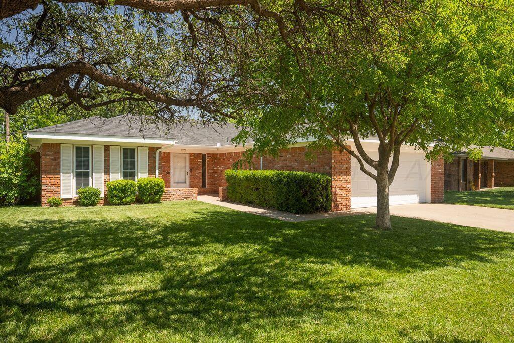 7935 Mitcham Drive Amarillo, TX 79121 - Photo 19 of 20 a view of a house with a big yard and large tree