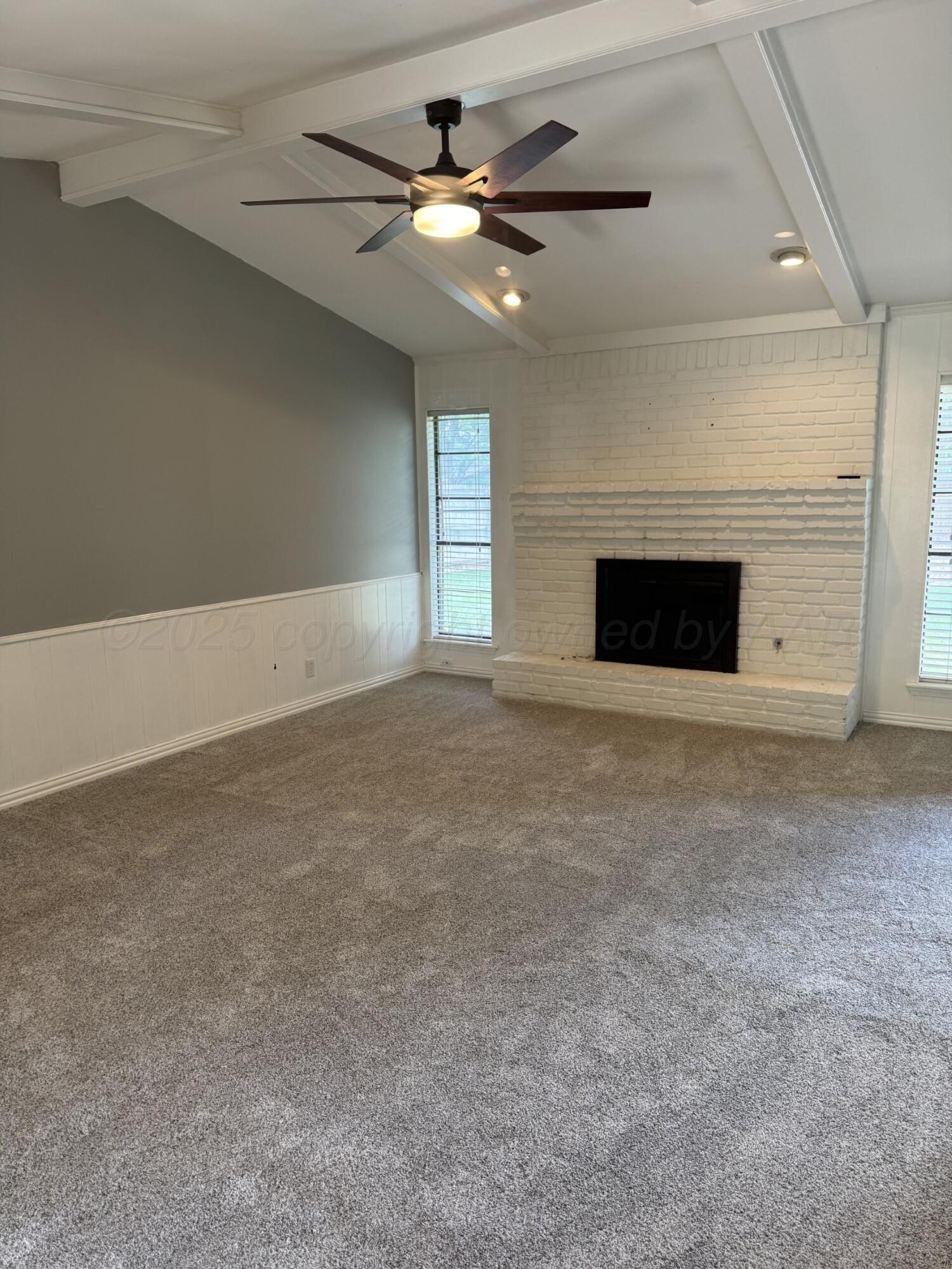 7935 Mitcham Drive Amarillo, TX 79121 - Photo 3 of 20 a view of an empty room with a fireplace