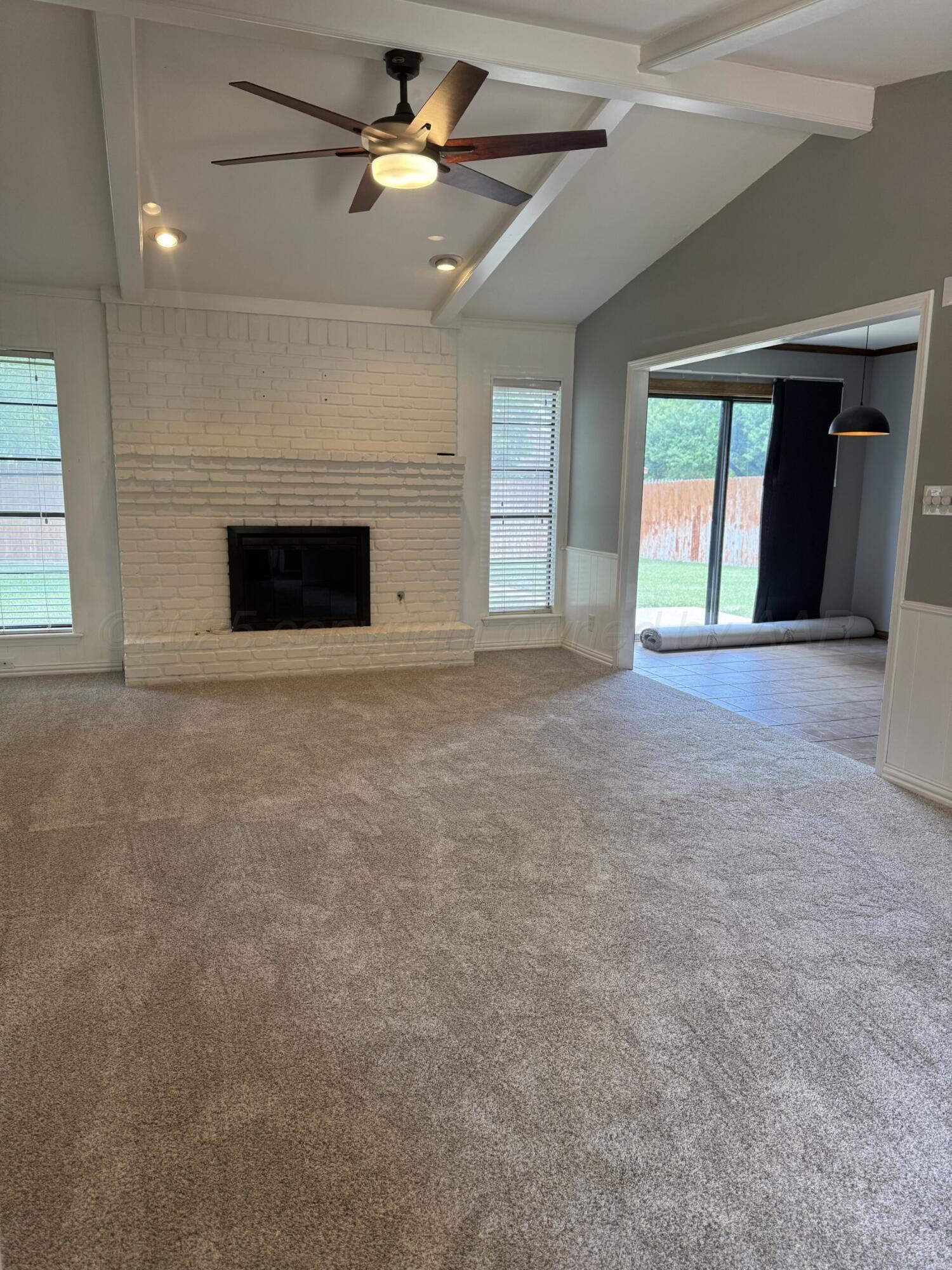 7935 Mitcham Drive Amarillo, TX 79121 - Photo 4 of 20 a view of an empty room with a fireplace and a window