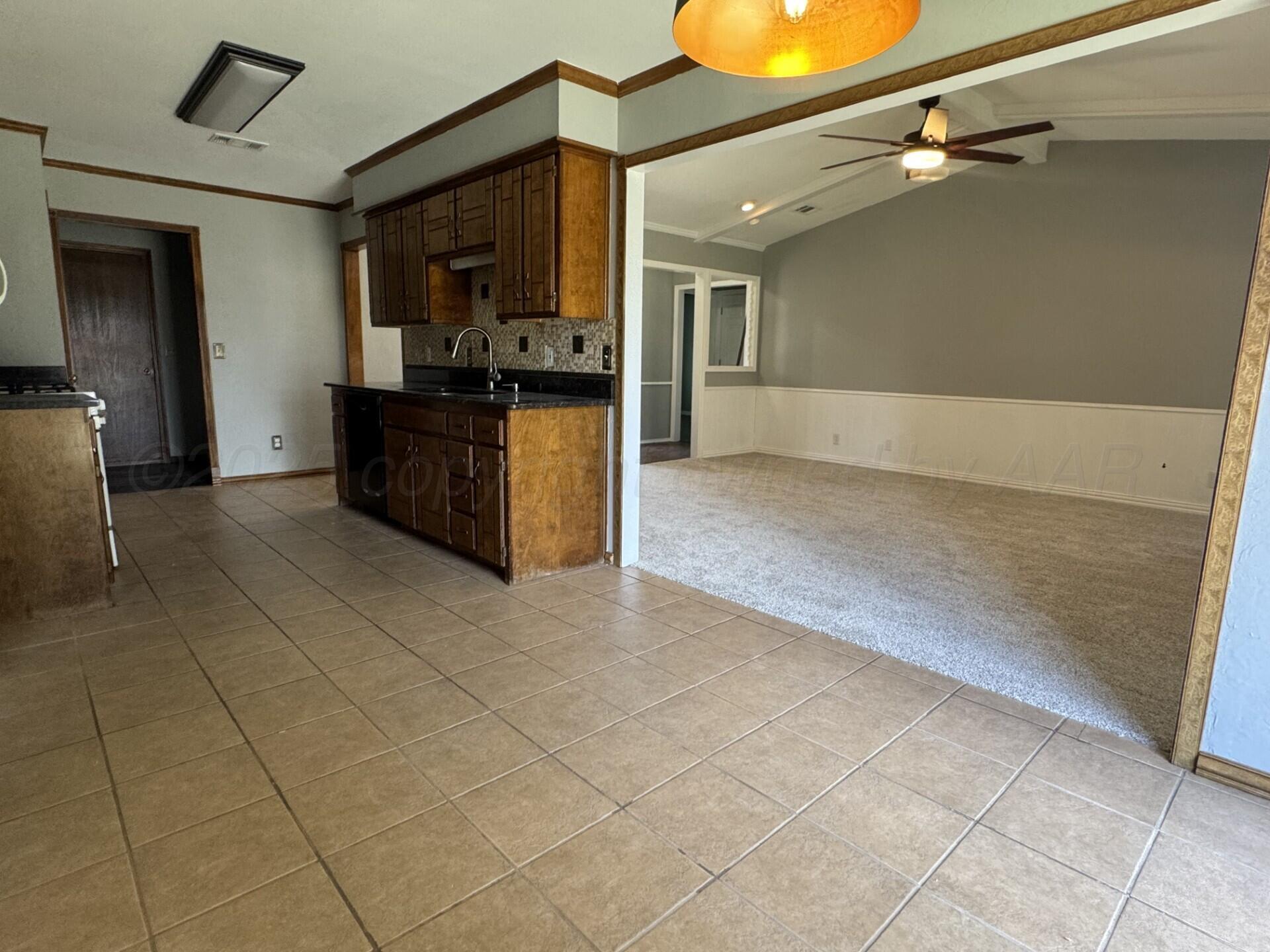 7935 Mitcham Drive Amarillo, TX 79121 - Photo 8 of 20 a view of a kitchen with a sink and cabinets