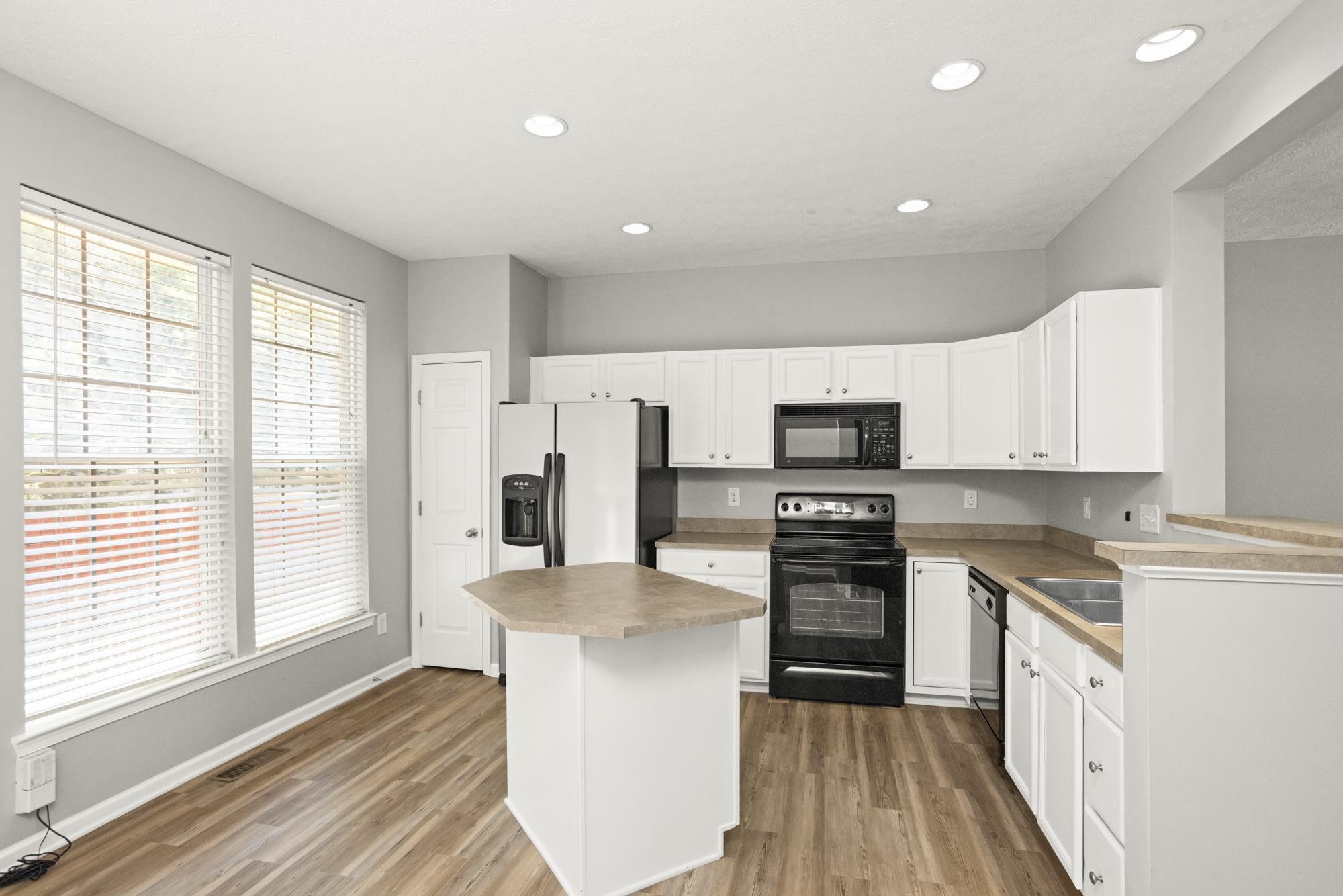 7277 Charlotte Pike, Unit 227 Nashville, TN 37209 - Photo 11 of 36 a kitchen with white cabinets and stainless steel appliances