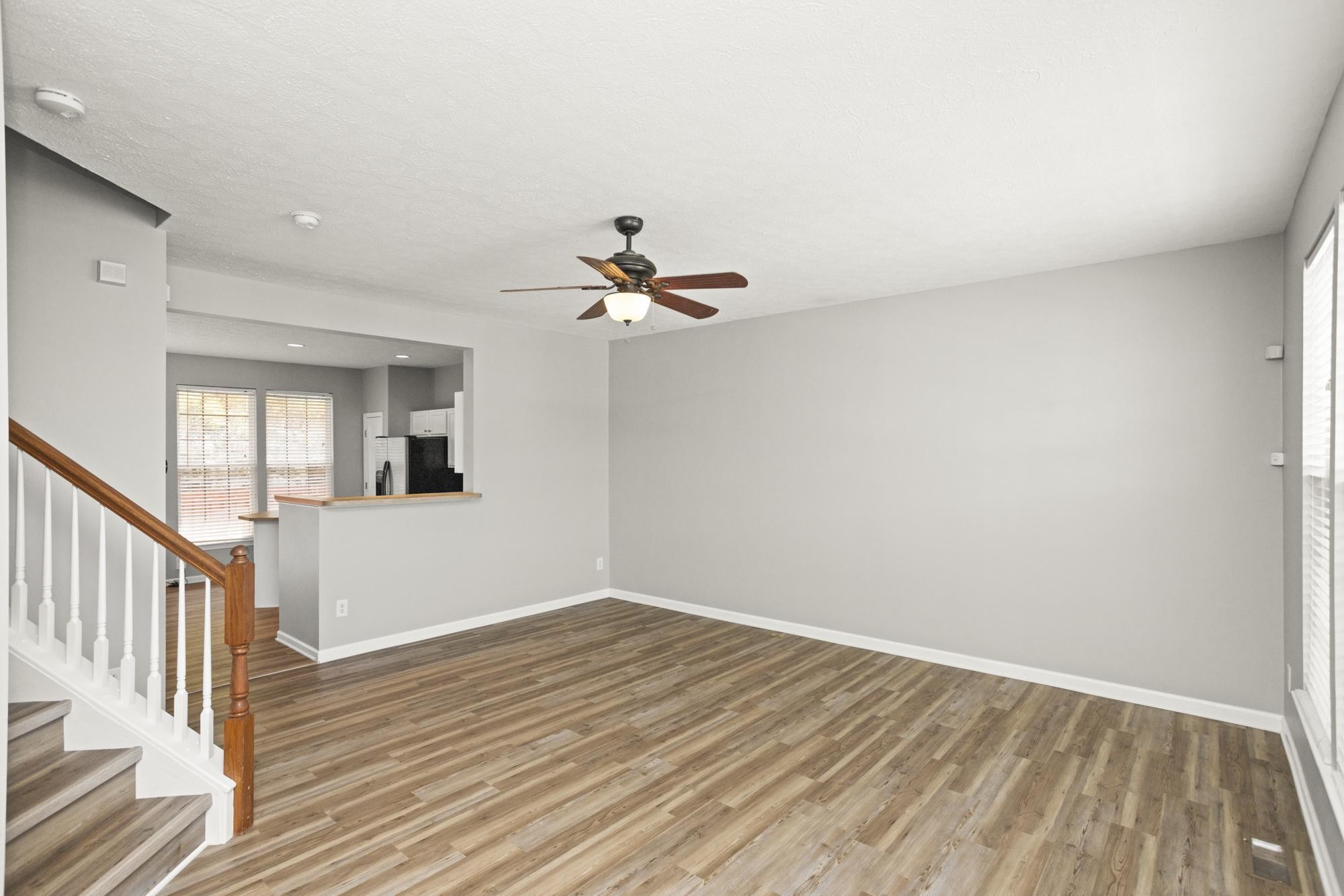 7277 Charlotte Pike, Unit 227 Nashville, TN 37209 - Photo 18 of 36 a view of a livingroom with wooden floor and a ceiling fan