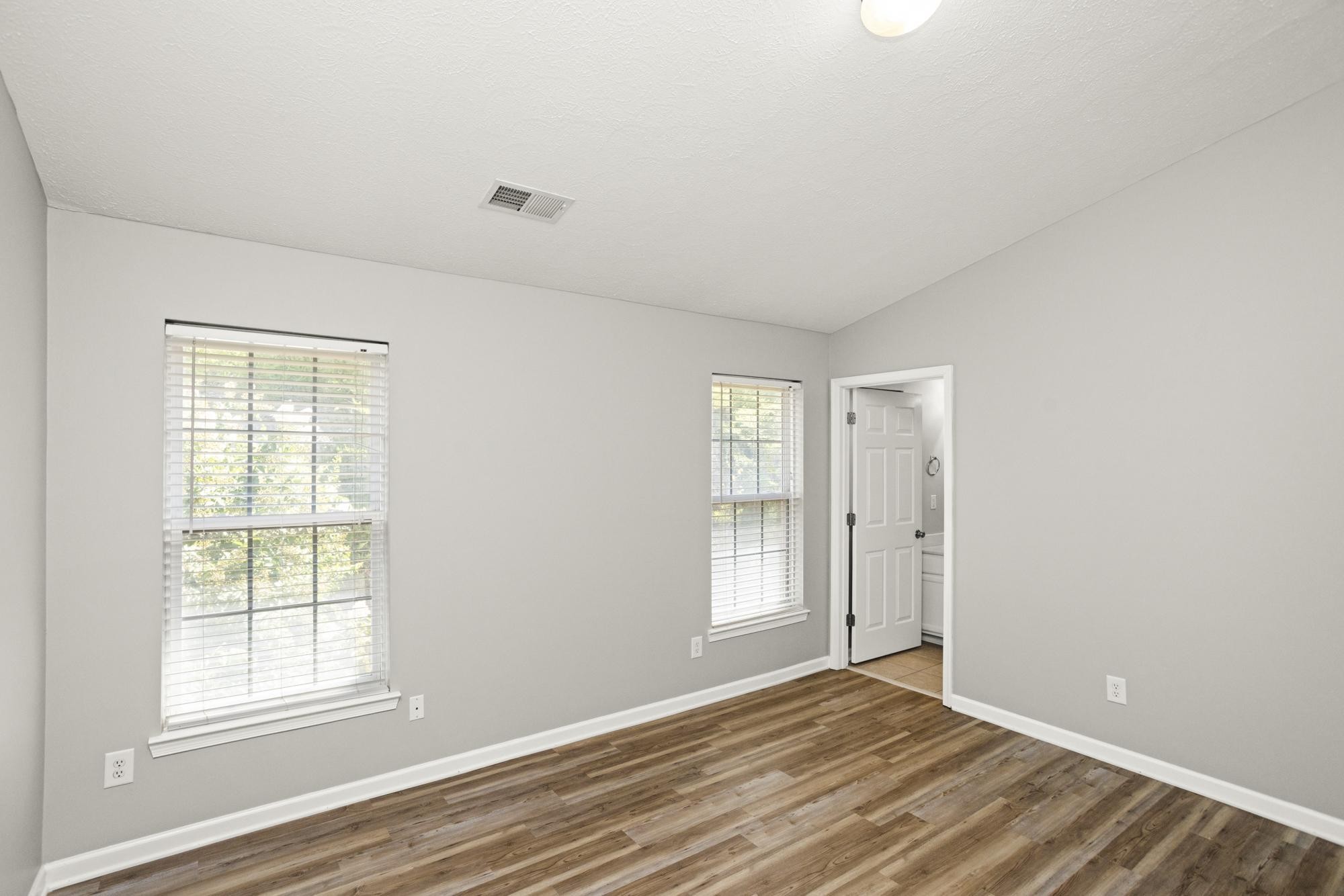 7277 Charlotte Pike, Unit 227 Nashville, TN 37209 - Photo 20 of 36 a view of an empty room with wooden floor and a window