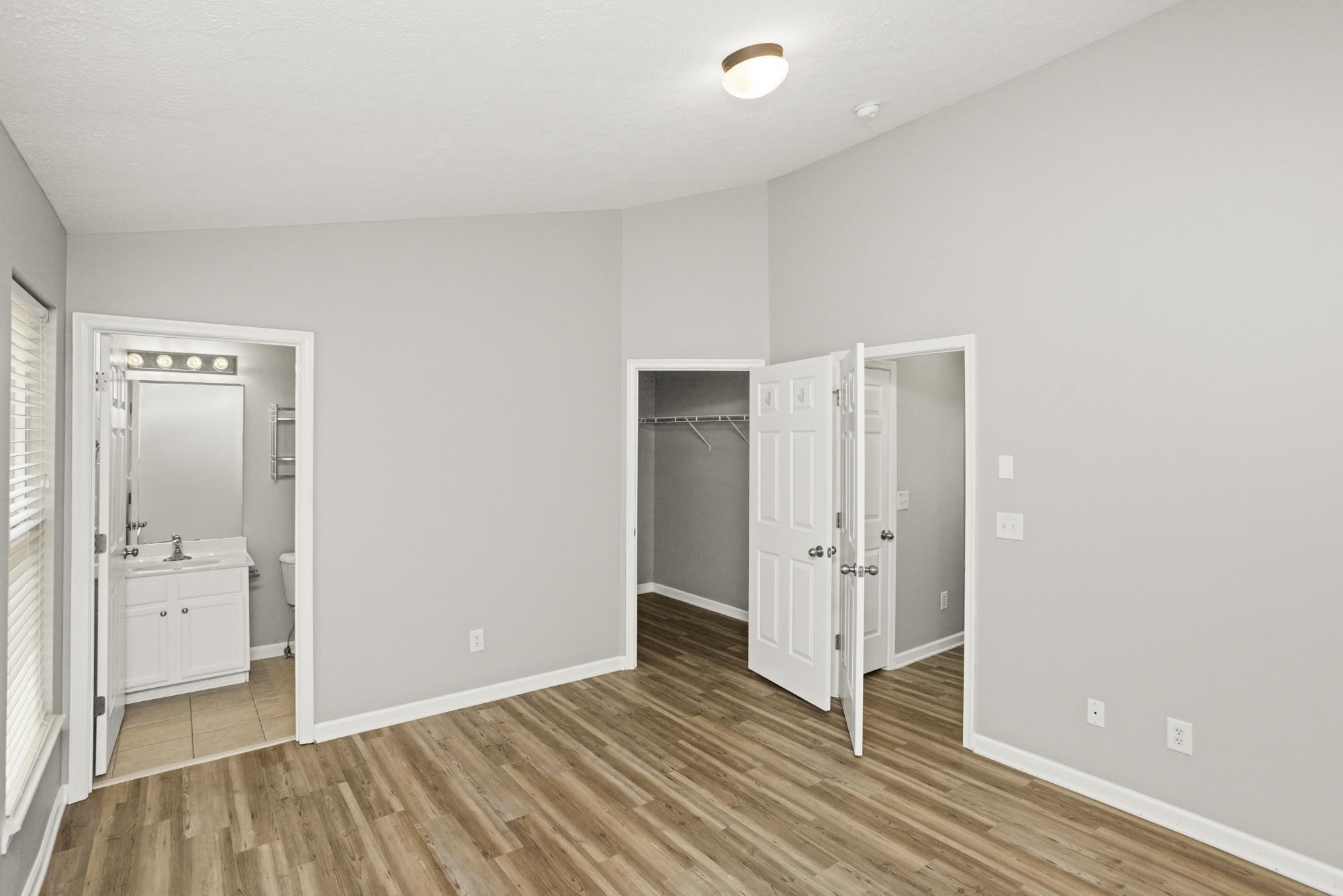7277 Charlotte Pike, Unit 227 Nashville, TN 37209 - Photo 21 of 36 a view of a hallway with wooden floor and front door