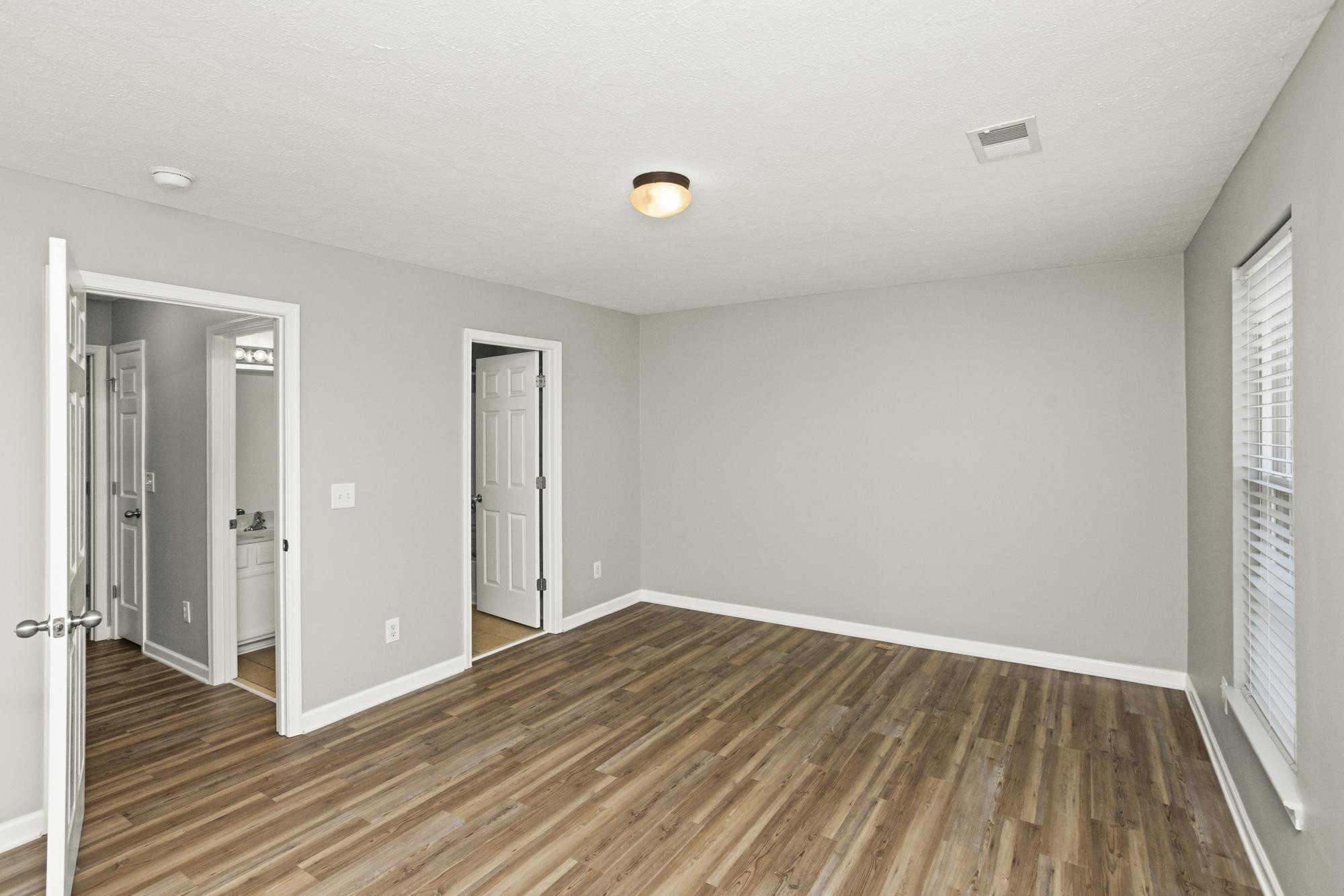 7277 Charlotte Pike, Unit 227 Nashville, TN 37209 - Photo 28 of 36 wooden floor in an empty room with a window